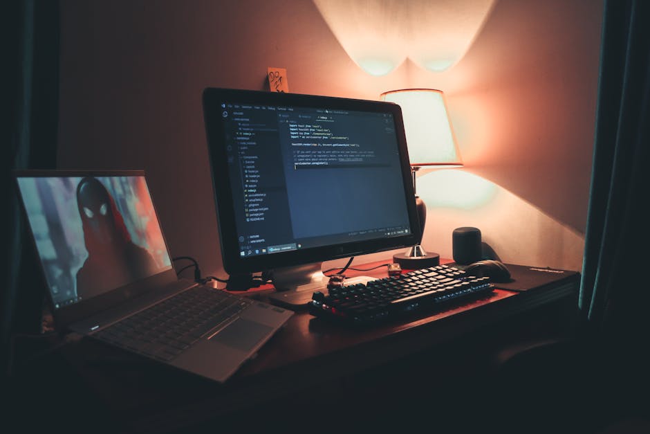 Warmly lit home office with dual screens for coding and programming. Perfect modern workspace for tech enthusiasts.